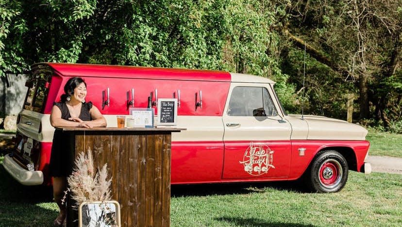 Daniela Ricci smiles next to her Tap Truck at a wedding.