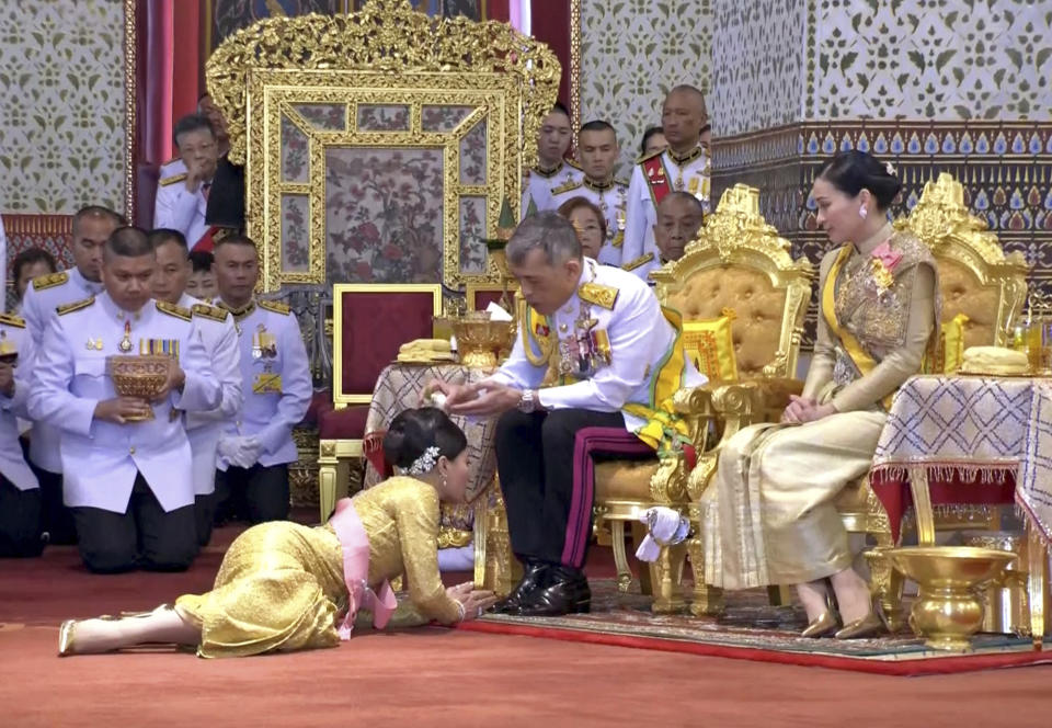 In this image made from video, Thailand’s King Maha Vajiralongkorn, center, and Queen Suthida, right, attend the second of a three-day coronation ceremony for Thai King Maha Vajiralongkorn that includes bestowing of the royal title and granting of ranks to members of royalty at Grand Palace in Bangkok, Sunday, May 5, 2019. Thailand's King Maha Vajiralongkorn was officially crowned Saturday amid the splendor of the country's Grand Palace, taking the central role in an elaborate centuries-old royal ceremony that was last held almost seven decades ago.(Thai TV Pool via AP)