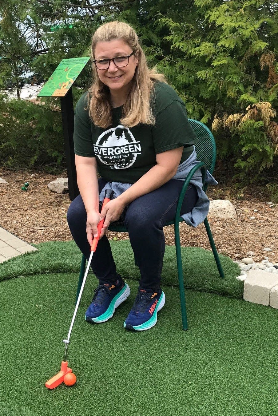 Kerry Johnson, owner of Evergreen Miniature Golf in Fish Creek, demonstrates how to use the hinged, adaptable putter that those in wheelchairs can use to play her course, which is accessible for all 18 holes.
