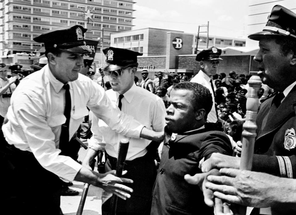 Metro policemen grabbed John Lewis, center, one of the leaders of the civil rights demonstrators at Morrison's Cafeteria on West End Avenue on April 29, 1964. Lewis was the first person of many to be arrested by the police.