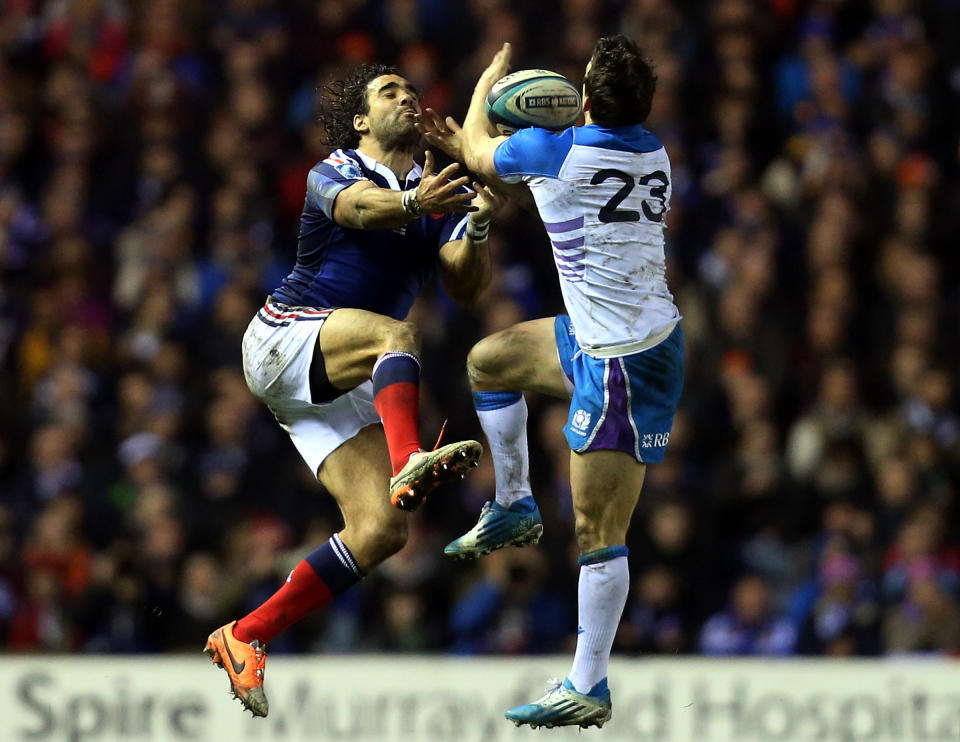 France's Yohan Huget, left, is tackled by Scotland's Max Evans, right, during their Six Nations rugby union international match at Murrayfield in Edinburgh, Scotland, Saturday March 8, 2014. (AP Photo/Scott Heppell)