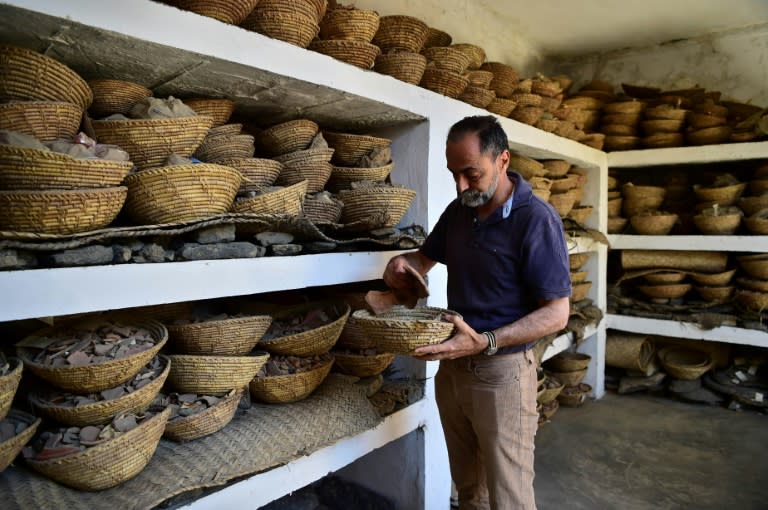 Italian archaeologist Luca Maria Olivieri looks through fragments of the Buddha of Swat, dynamited by the Taliban in 2007