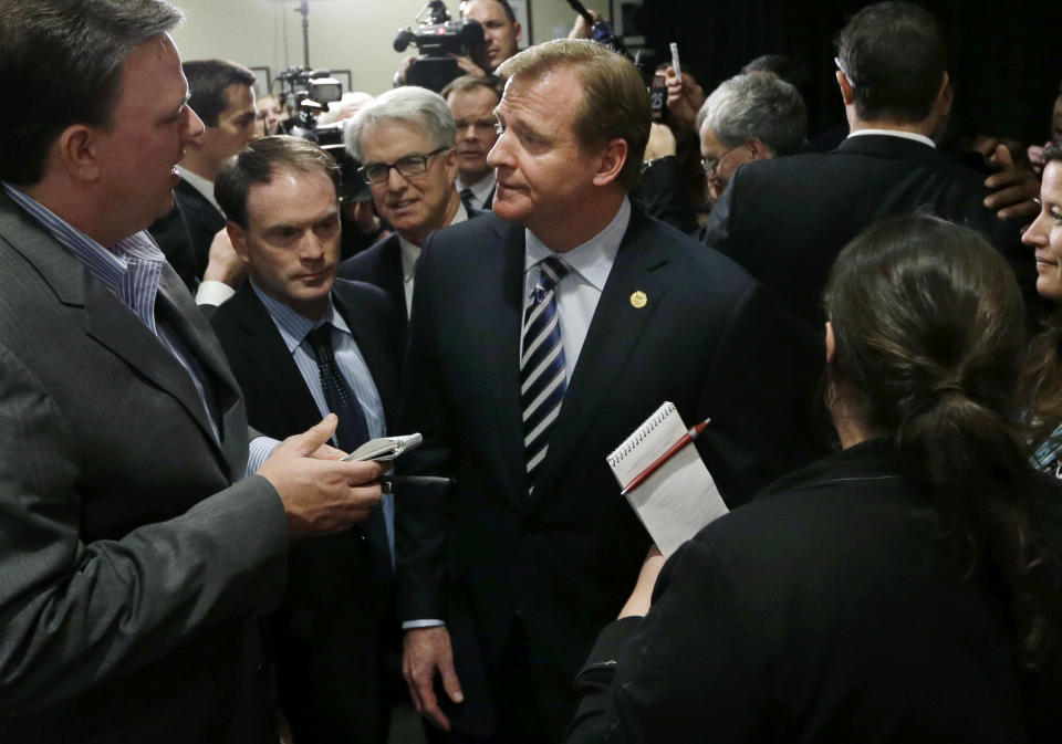 NFL football commissioner Roger Goodell is surrounded by reporters after delivering a Dean's Distinguished Lecture at Harvard School of Public Health in Boston, Thursday, Nov. 15, 2012, where he discussed some of the rules that have been created to limit concussions in the game of football. Goodell said the league will do what it needs to do to protect the safety of its 1,800 players. (AP Photo/Elise Amendola)