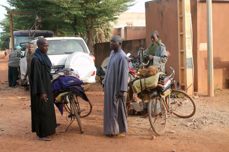 FILE PHOTO: Fulani men sell traditional fabric on a road in Sevare