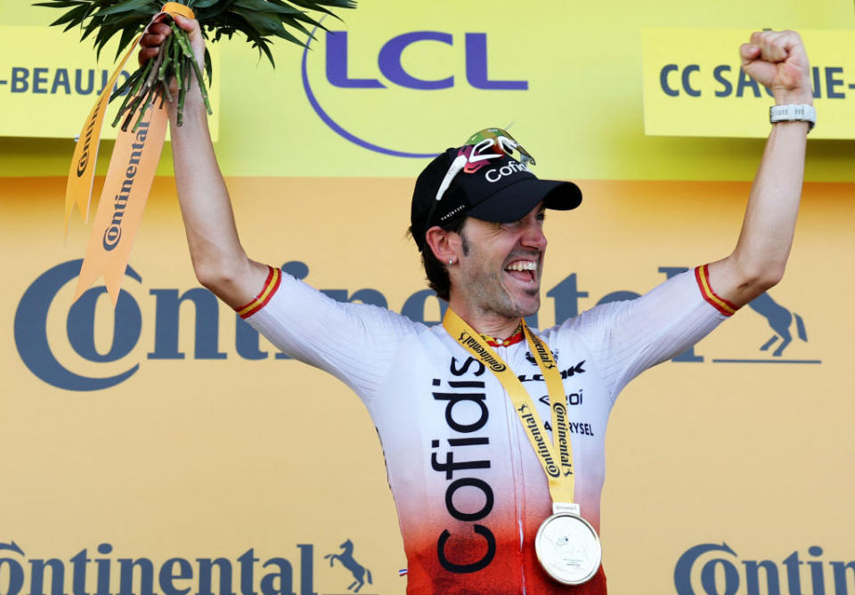 Cofidis' Spanish rider Ion Izaguirre Insausti celebrates his victory on the podium after winning the 12th stage of the 110th edition of the Tour de France cycling race, 169 km between Roanne and Belleville-en-Beaujolais, in central-eastern France, on July 13, 2023. (Photo by Thomas SAMSON / AFP)