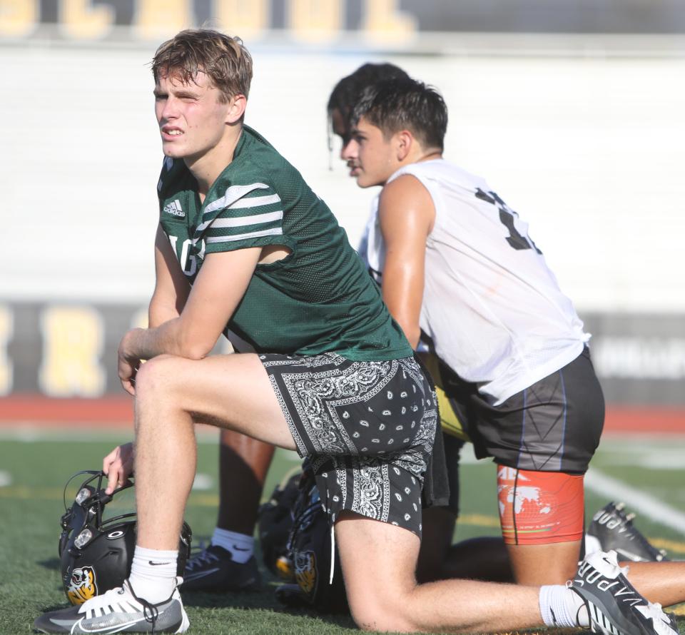 Mason Bray takes a knee during practice at Saguaro High School football stadium in Scottsdale on Aug. 1, 2023.