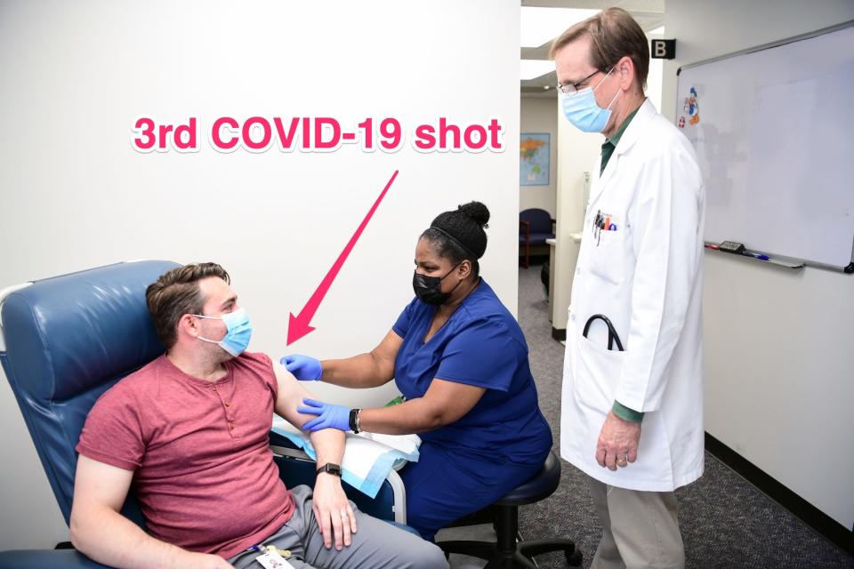 trial participant joseph hyser gets a covid-19 vaccine as the principal investigator looks on at baylor college of medicine