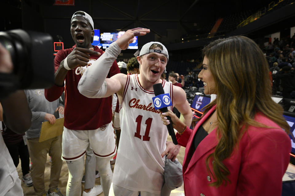 Charleston guard Ryan Larson (11) is interviewed after winning the championship basketball game of the Colonial Athletic Association tournament. (AP Photo/Nick Wass)