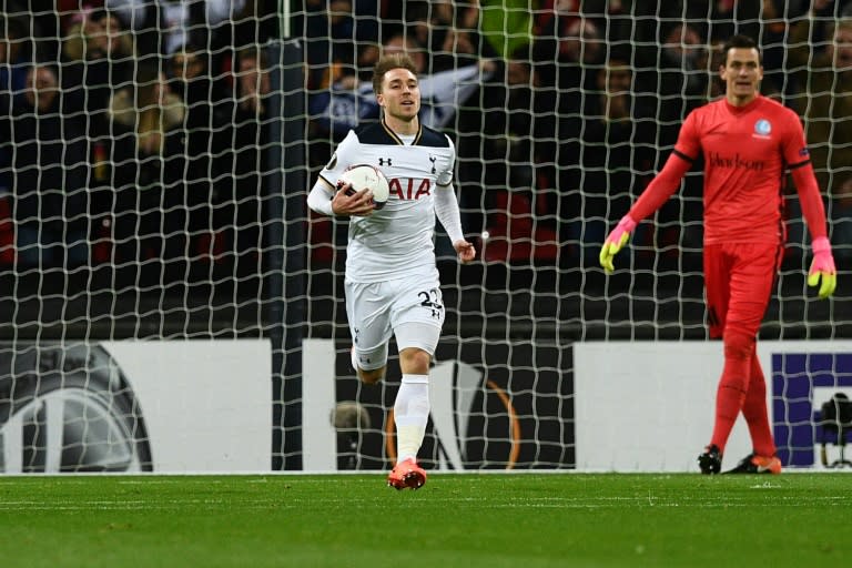 Tottenham Hotspur's midfielder Christian Eriksen (C) collects the ball after scoring the opening goal during the UEFA Europa League Round of 32 second-leg football match between Tottenham Hotspur and KAA Gent on February 23, 2017