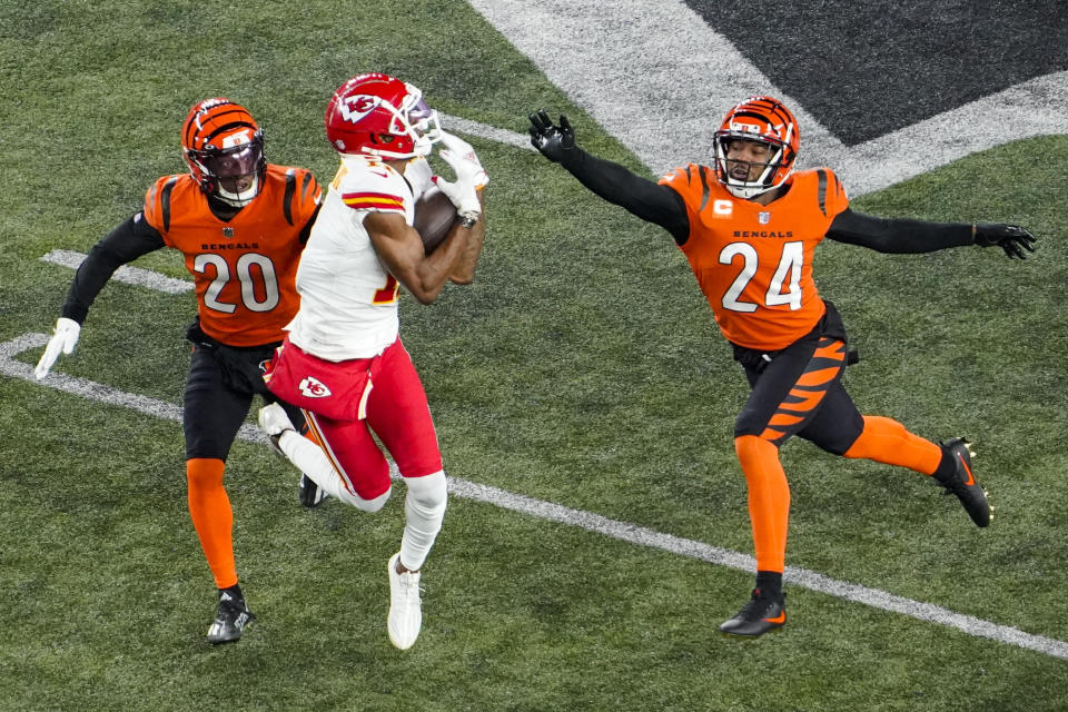 Kansas City Chiefs wide receiver Marquez Valdes-Scantling (11) makes a catch between Cincinnati Bengals cornerback Eli Apple (20) and safety Vonn Bell (24) in the second half of an NFL football game in Cincinnati, Fla., Sunday, Dec. 4, 2022. (AP Photo/Joshua Bickel)