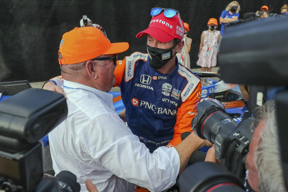 Team owner Chip Ganassi, left, congratulates Scott Dixon on winning the NTT IndyCar Series Championship following an IndyCar auto race Sunday, Oct. 25, 2020, in St. Petersburg, Fla. (AP Photo/Mike Carlson)