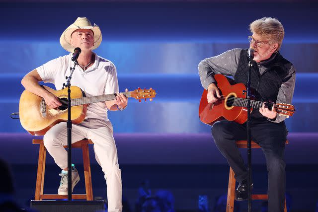 <p>Christopher Polk/Variety via Getty</p> Kenny Chesney and Mac McAnally performing a tribute to Jimmy Buffett at the 2023 CMA Awards