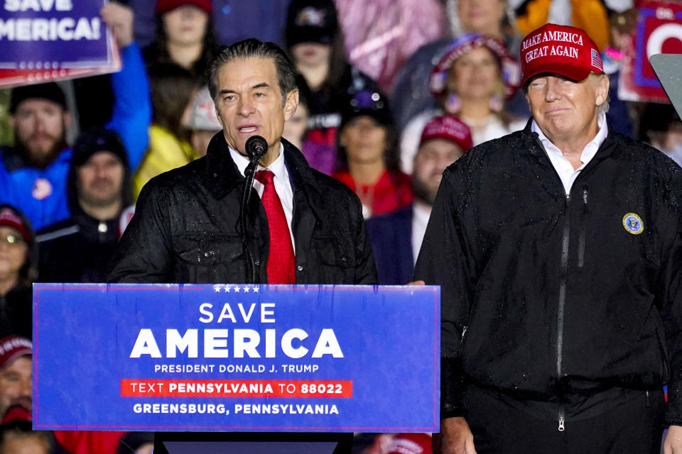 Mehmet Oz stands at a podium, flanked by former President Donald Trump.