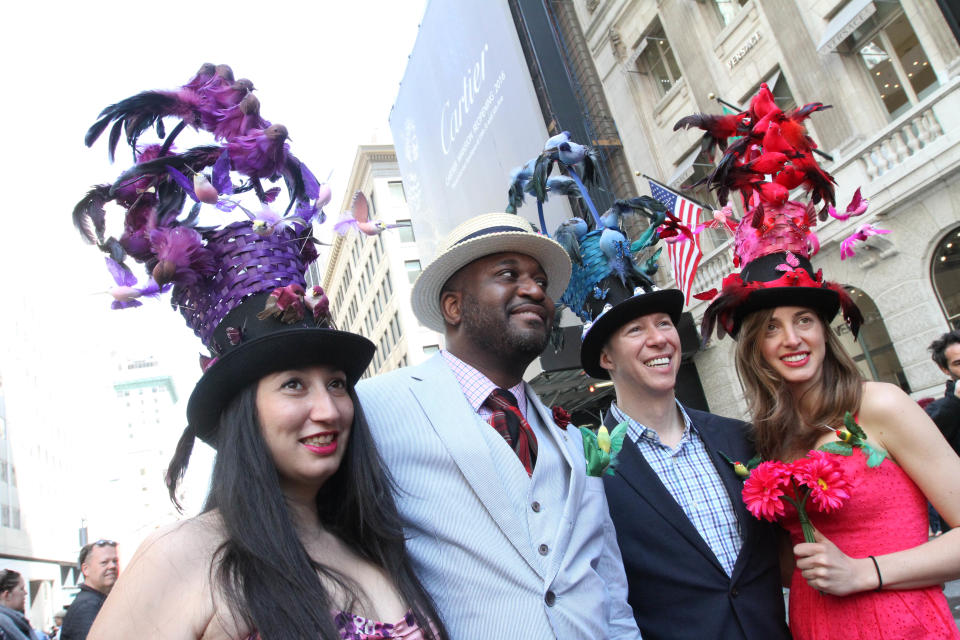 Dressed for the occasion, from left, Jane Pastrana, Dwayne Skeete, Tom Nickel, and Allison Devereux pose for photographs as they take part in the Easter Parade along New York's Fifth Avenue, Sunday, April 20, 2014. (AP Photo/Tina Fineberg)