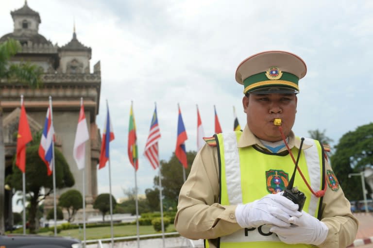 A policeman directs traffic in Vientiane on July 23, 2016, as Laos hosts the 49th South East Asian Nations (ASEAN) meeting