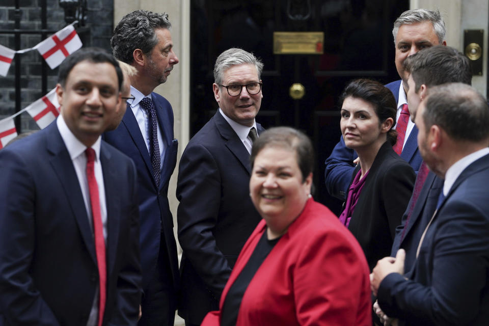 Britain's Prime Minister Keir Starmer, background center, poses for a photograph with the new intake of Scottish Labour Members of Parliament, outside no 10 Downing Street, in London, Tuesday, July 9, 2024. (Lucy North/PA via AP)