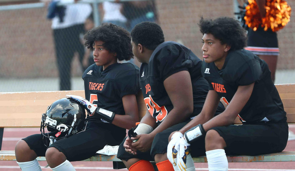 DeMarcus Henry, left, and his brother, Chris Henry Jr., right, sons of former Cincinnati Bengal Chris Henry, played junior high football for Withrow. They both have transferred to West Clermont where Henry Jr. will be a freshman with the Wolves. DeMarcus is in eighth grade.