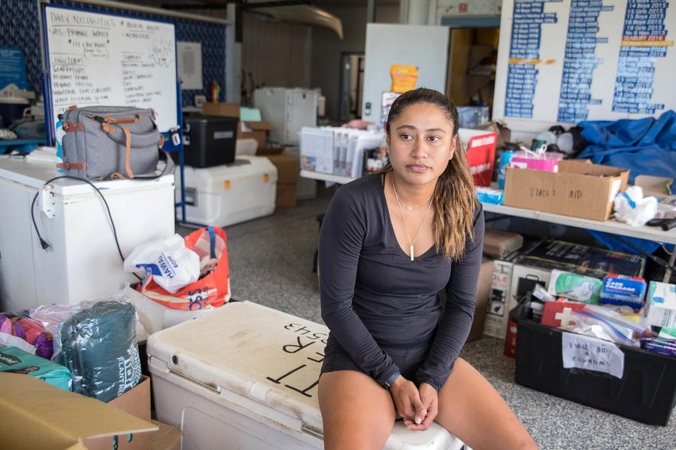 [15 August 2023 - Maui, HI] Coordinator Hiilei Luuwai waits to distribute supplies at the Hawaiian Canoe Club organize supplies for delivery to Lahaina. (Brock Stoneham / NBC News)