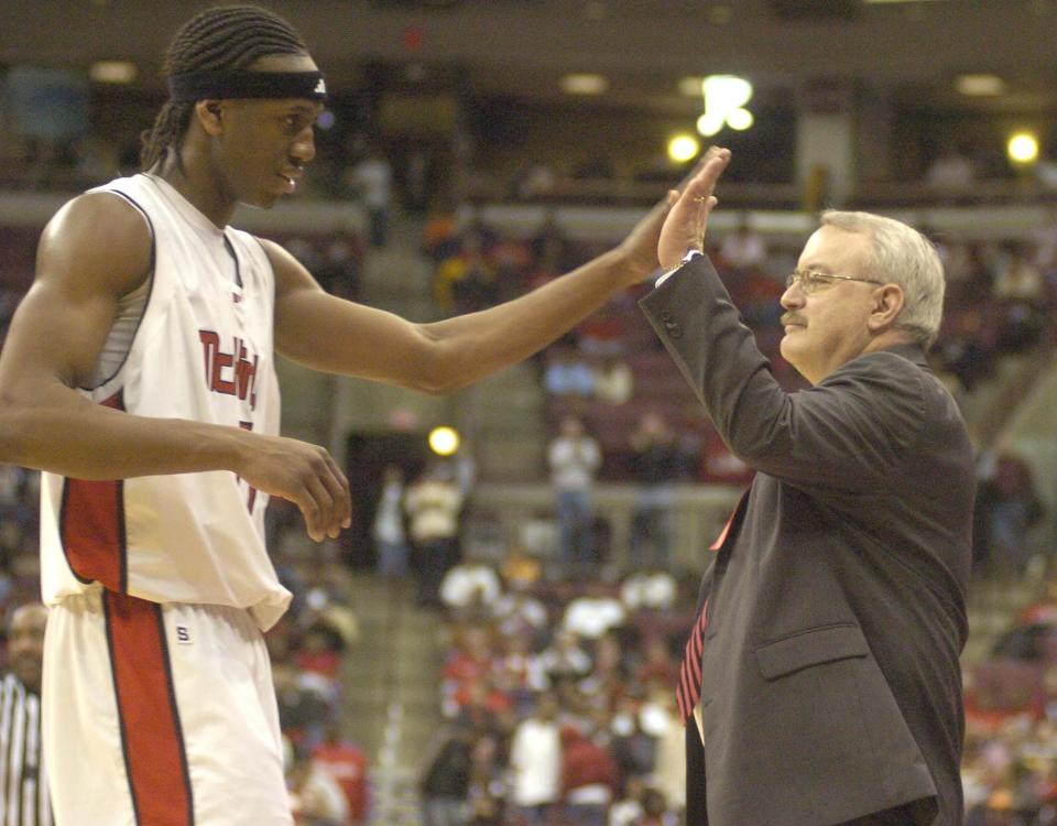 McKinley High School basketball standout Raymar Morgan gives coach Dave Hoover a high five after coming off the court late in the fourth quarter of their Division I state championship victory, Saturday, March 25, 2006.