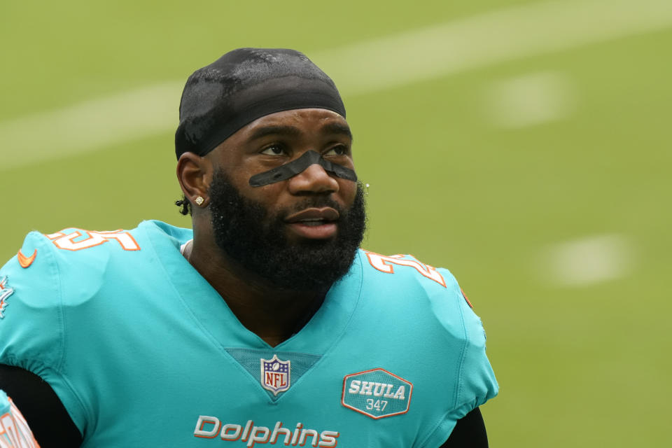 FILE - Miami Dolphins cornerback Xavien Howard (25) warms up before an NFL football game against the Cincinnati Bengals in Miami Gardens, Fla., in this Sunday, Dec. 6, 2020, file photo. All-Pro cornerback Xavien Howard joined the rest of the Miami Dolphins reporting for training camp Tuesday, July 27, 2021, after he sat out mandatory minicamp because he's unhappy about his contract. (AP Photo/Wilfredo Lee, File)