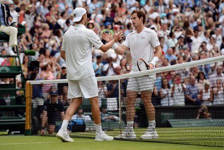 Great Britain's Andy Murray with Italy's Andreas Seppi after winning their third round match Mandatory Credit: Action Images / Tony O'Brien Livepic