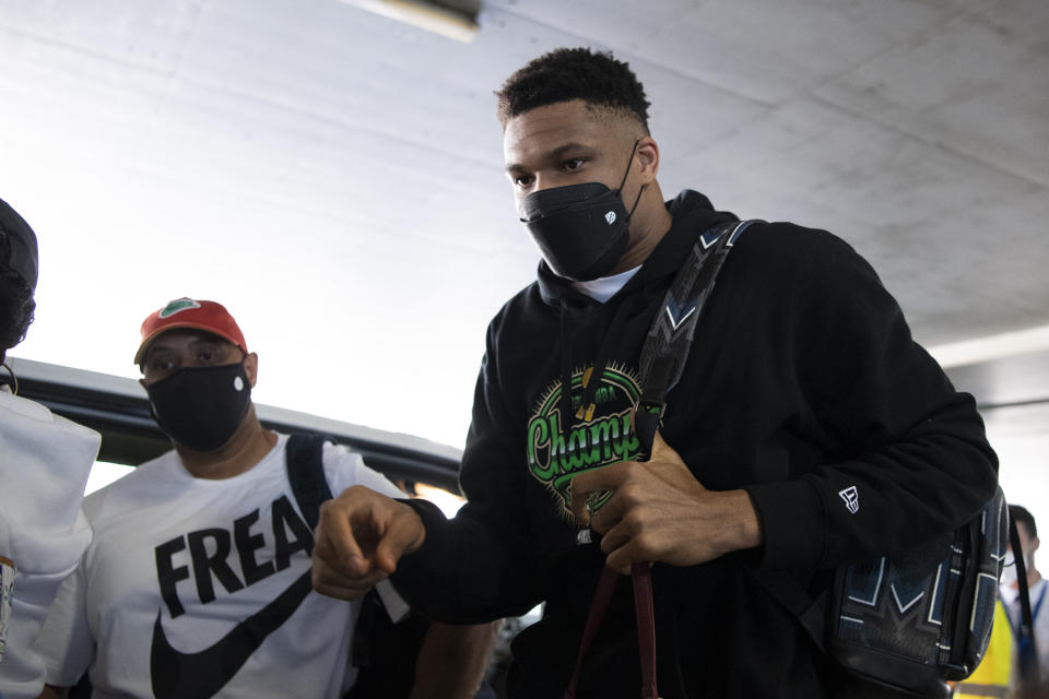 NBA Champion Giannis Antetokounmpo, of the Milwaukee Bucks, who was named NBA Finals Most Valuable Player, arrives at the Eleftherios Venizelos International Airport, in Athens, Greece, Sunday, Aug. 1, 2021. The NBA champion and finals MVP plans to stay in Greece for a few days, before returning to the U.S., where his girlfriend expects their second child later this month. (AP Photo/Michael Varaklas)