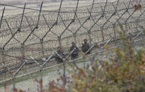 South Korean army soldiers patrol along the barbed-wire fence in Paju, South Korea, near the border with North Korea, Friday, Nov. 16, 2018. North Korean leader Kim Jong Un observed the successful test of "a newly developed ultramodern tactical weapon," the nation's state media reported Friday, though it didn't describe what sort of weapon it was.(AP Photo/Ahn Young-joon)