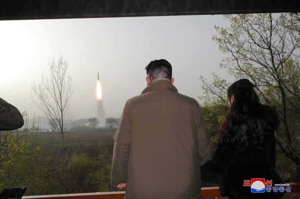 North Korean leader Kim Jong Un (left) and his daughter Kim Ju Ae observing the test firing of a new solid-fuel Hwasong-18 ICBM at an undisclosed location in North Korea on 13 April 2023 (EPA)