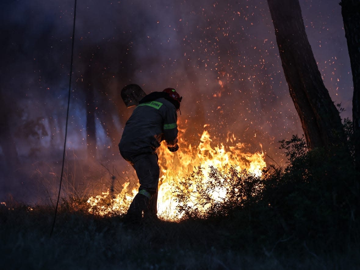 A wildfire burn in Megara, Greece, earlier this week. Experts say the wildfires Europe has faced this summer are something the world will see more of in future — along with the extreme heat that has accompanied them. (Aris Oikonomou/AFP/Getty Images - image credit)