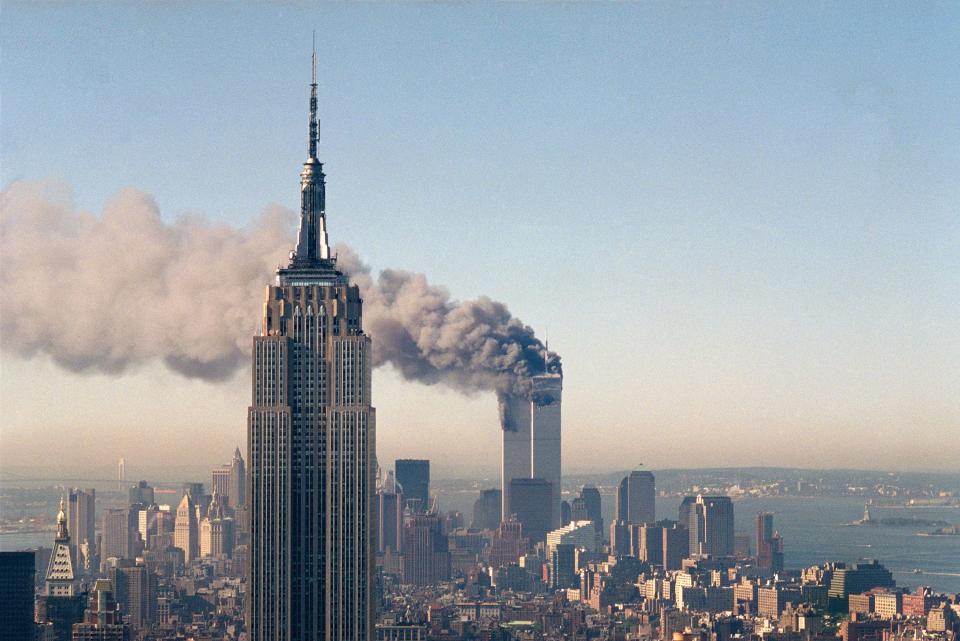 FILE - The twin towers of the World Trade Center burn behind the Empire State Building, Tuesday Sept. 11, 2001. in New York. (AP Photo/Marty Lederhandler, File)