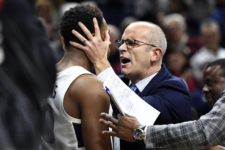 Connecticut head coach Dan Hurley congratulates Brendan Adams (10) after Adams scored to put the team ahead late in the second half of an NCAA college basketball game against South Florida, Sunday, Feb. 23, 2020, in Storrs, Conn. (AP Photo/Stephen Dunn)