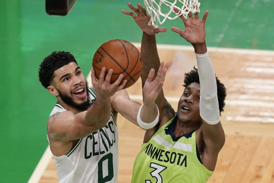 Boston Celtics forward Jayson Tatum (0) goes to the basket against Minnesota Timberwolves forward Jaden McDaniels (3) during the second quarter of an NBA basketball game Friday, April 9, 2021, in Boston. (AP Photo/Elise Amendola)