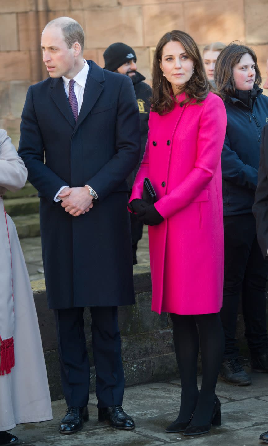 <p>In a hot pink double breasted coat by Mulberry, a black clutch, gloves, tights, and suede pumps during a visit to Coventry, England with Prince William. </p>