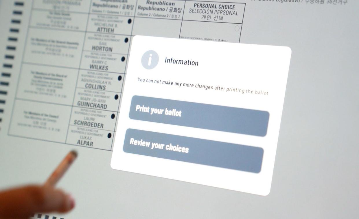 After using the touch screen to select the candidates, the voter will print the ballot before scanning it into a ballot machine.