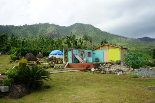 Irvince Auguiste, his wife and three sons sleep in tents next to the ruins of their five-bedroom Touna Village home