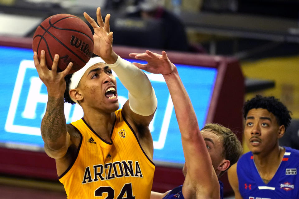 Arizona State forward Jalen Graham (24) shoots over Houston Baptist guard Ty Dalton, center, and Pedro Castro during the first half of an NCAA college basketball game, Sunday, Nov. 29, 2020, in Tempe, Ariz. (AP Photo/Rick Scuteri)