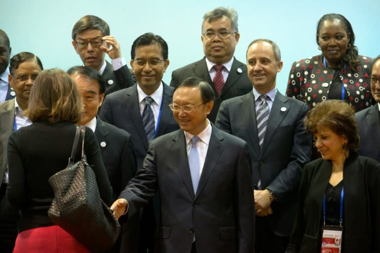 Chinese State Councilor Yang Jiechi (C) greets attendees while posing for a group photo at a meeting of G20 representatives in Beijing, on January 14, 2016