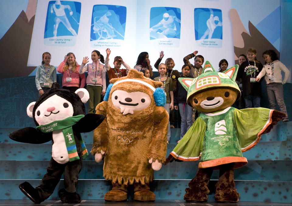 The mascots for the Vancouver 2010 Winter Olympics, from left, Miga, Quatchi and Sumi pose for photographers following their debut to students in Surrey, British Columbia, on Nov. 27, 2007. (Jonathan Hayward/The Canadian Press via AP)