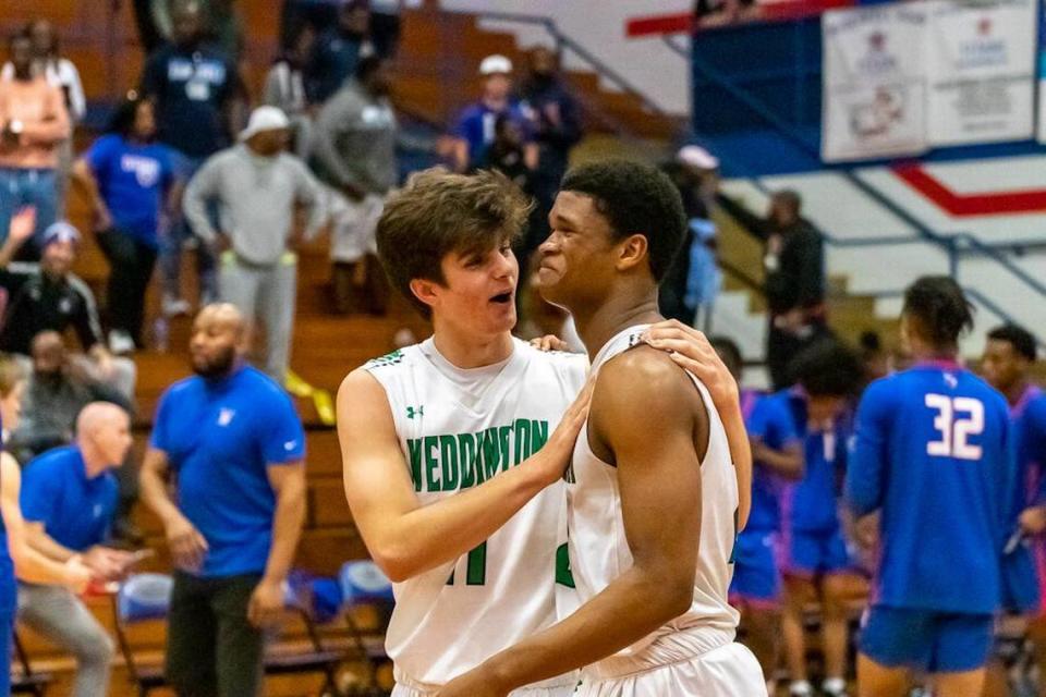 Weddington players Chase Lowe and Nolan Dunphy embrace them in an emotion hug after their win over North Meck