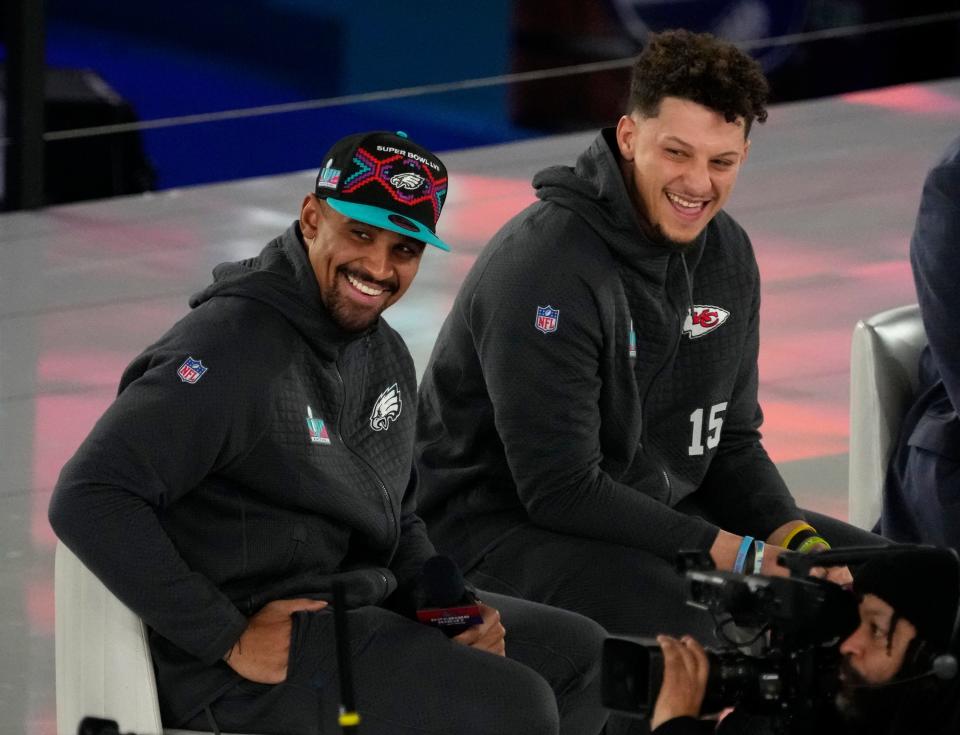 Philadelphia Eagles quarterback Jalen Hurts (left) and Kansas City Chiefs quarterback Patrick Mahomes (right) take the stage during Super Bowl Opening Night.