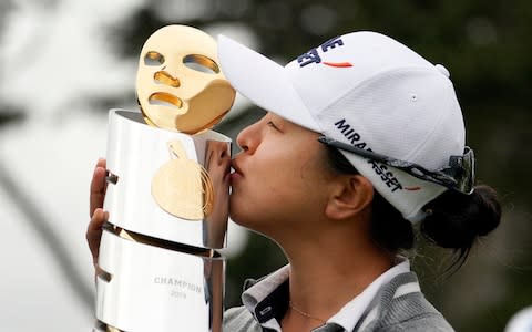 Kim Sei-young, of South Korea, kisses her trophy on 18th green of the Lake Merced Golf Club - Credit: AP Photo/Tony Avelar