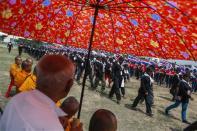 Buddhist monks pray as members of the "Volunteers' Ward to protect the Nation's Democracy" group take part during a march marking the end of their two days training at the stadium in Nakhon Ratchasima, Northeastern province of Thailand, April 21, 2014. REUTERS/Athit Perawongmetha