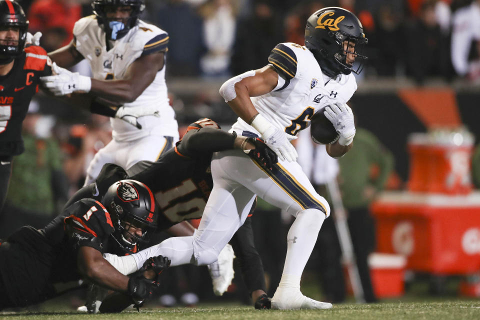 California running back Jaydn Ott is brought down by Oregon State linebacker Omar Speights and linebacker Andrew Chatfield Jr. during the first half of an NCAA college football game on Saturday, Nov 12, 2022, in Corvallis, Ore. (AP Photo/Amanda Loman)