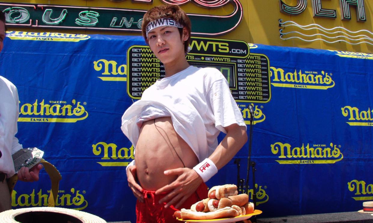 <span>Takeru Kobayashi at the 2002 Nathan’s hotdog contest, where he broke his own world record.</span><span>Photograph: Mychal Watts/WireImage</span>