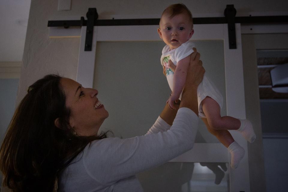 Christina Lambert plays with her daughter Brianna at her home in West Palm Beach.