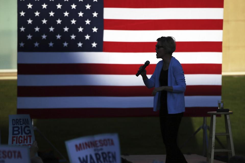 Democratic presidential candidate Elizabeth Warren, D-Mass., is silhouetted as she speaks during a rally Monday, Aug. 19, 2019, at Macalaster College during a campaign appearance in St. Paul, Minn. (AP Photo/Jim Mone)