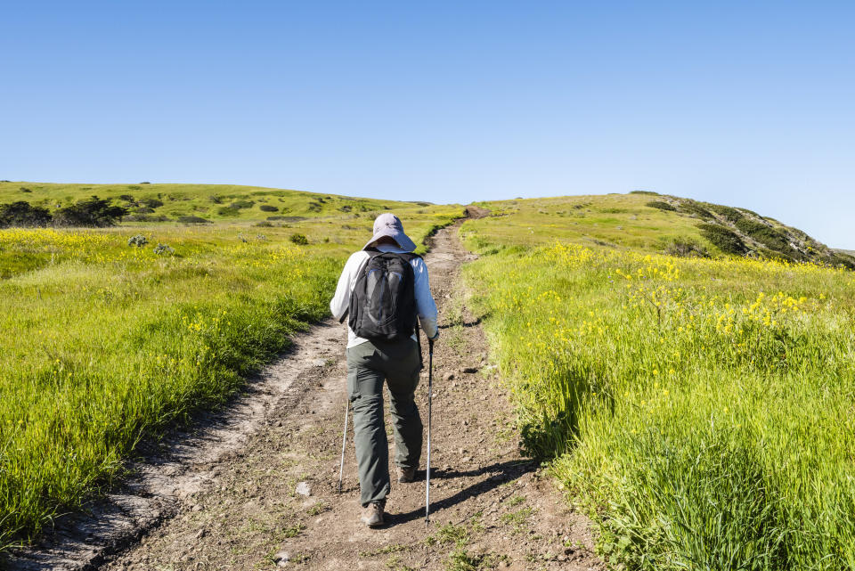 Hiking alone on a grassy mountain in Santa Cruz