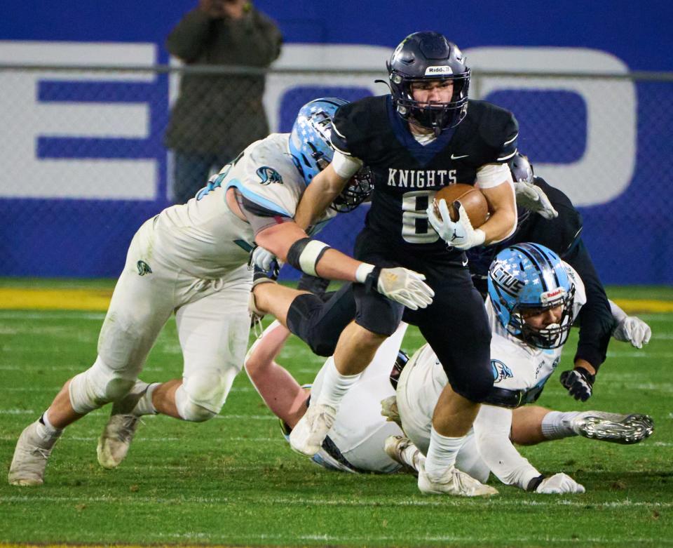 Higley Knights running back  Daxen Hall (8) attempts to break through the Cactus Cobras' defense during the AIA 5A state championship game at Sun Devil Stadium in Tempe on Friday, Dec. 9, 2022.