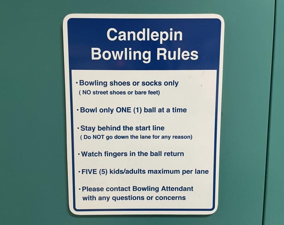 Signs with rules are posted throughout the bowling alley.