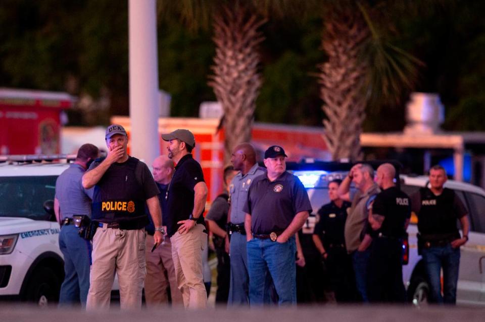 Law enforcement officers stand outside Surf Style in Biloxi after a chaotic shooting during Black Spring Break that left one police officer injured on Sunday, April 16, 2023.
